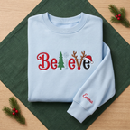 The Personalized Believe Christmas Tree Reindeer Antlers Santa Hat Embroidered Sweatshirt
