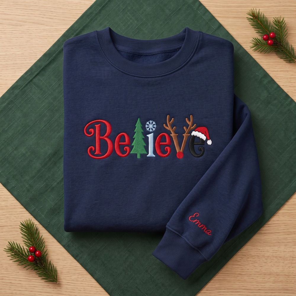 The Personalized Believe Christmas Tree Reindeer Antlers Santa Hat Embroidered Sweatshirt