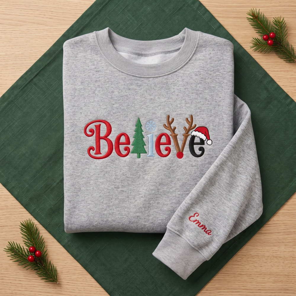 The Personalized Believe Christmas Tree Reindeer Antlers Santa Hat Embroidered Sweatshirt