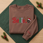 The Personalized Believe Christmas Tree Reindeer Antlers Santa Hat Embroidered Sweatshirt