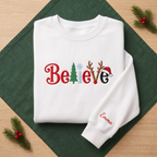 The Personalized Believe Christmas Tree Reindeer Antlers Santa Hat Embroidered Sweatshirt