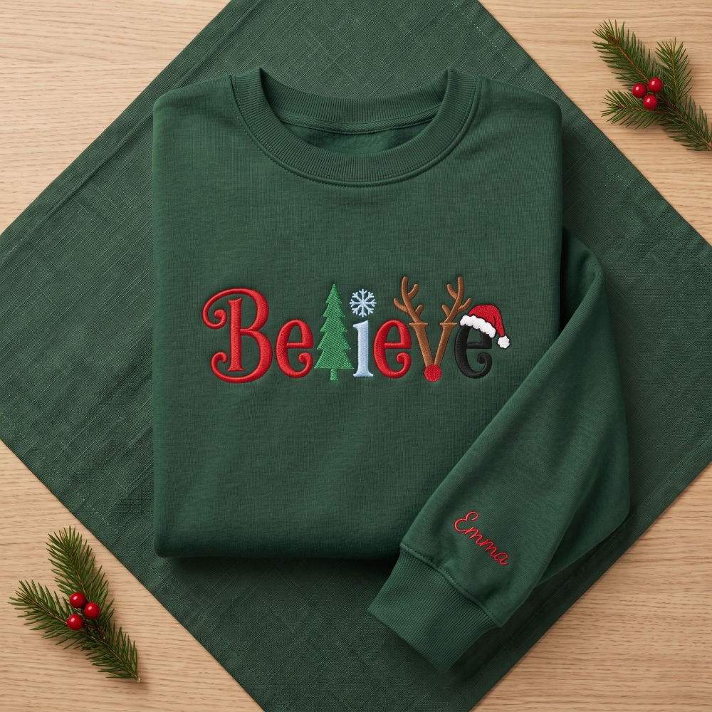 The Personalized Believe Christmas Tree Reindeer Antlers Santa Hat Embroidered Sweatshirt