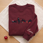 The Personalized Black Cats Christmas Mischief Santa Hat Tangled Lights Ornaments embroidered sweatshirt — front view