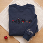 The Personalized Black Cats Christmas Mischief Santa Hat Tangled Lights Ornaments embroidered sweatshirt — front view