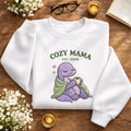 Cozy Mama Dinosaur Blanket Coffee EST Year embroidered sweatshirt — front view
