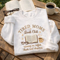 Tired Moms Book Club Coffee Chaos Chapters embroidered sweatshirt — front view