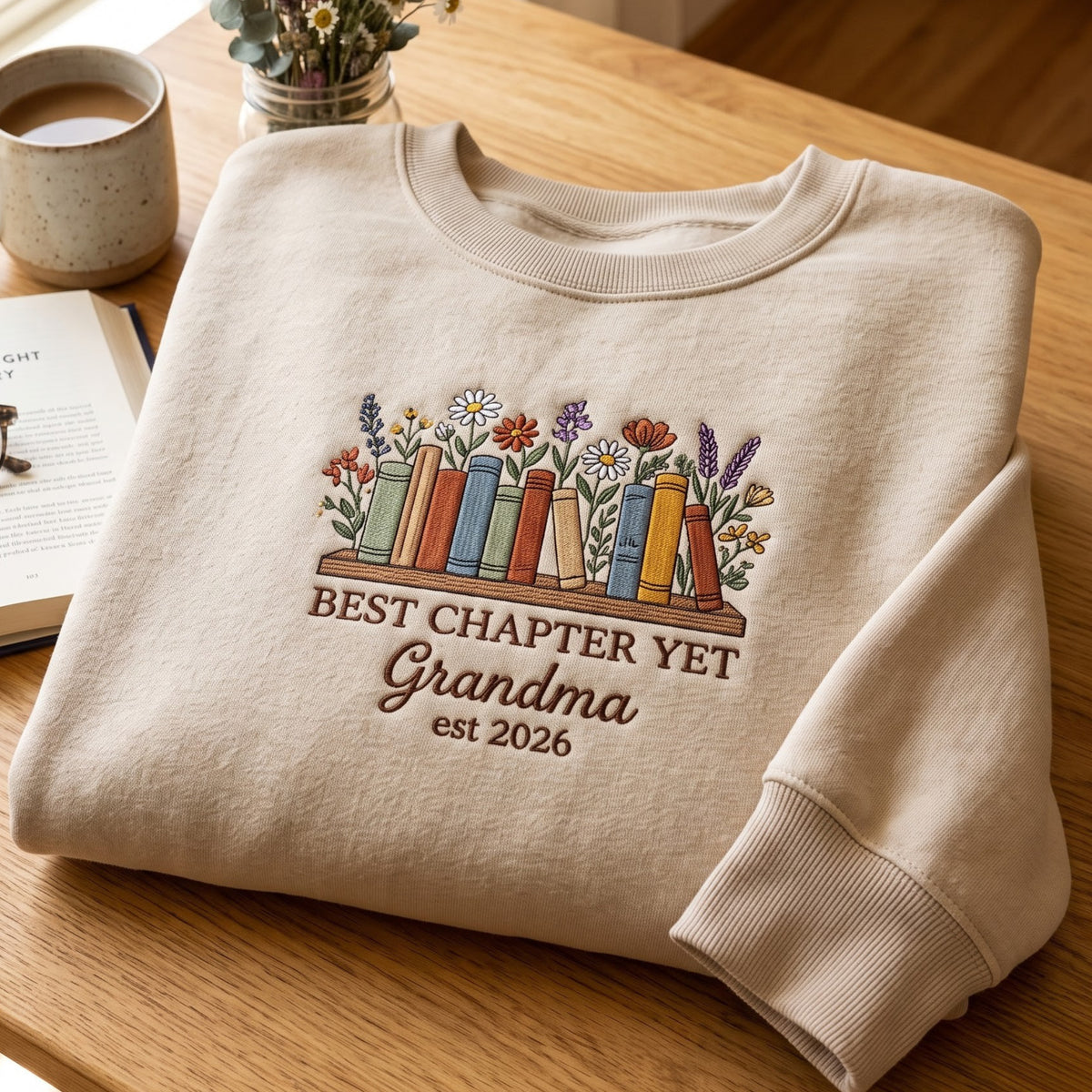 Best Chapter Yet Grandma EST 2026 Bookshelf embroidered sweatshirt — front view