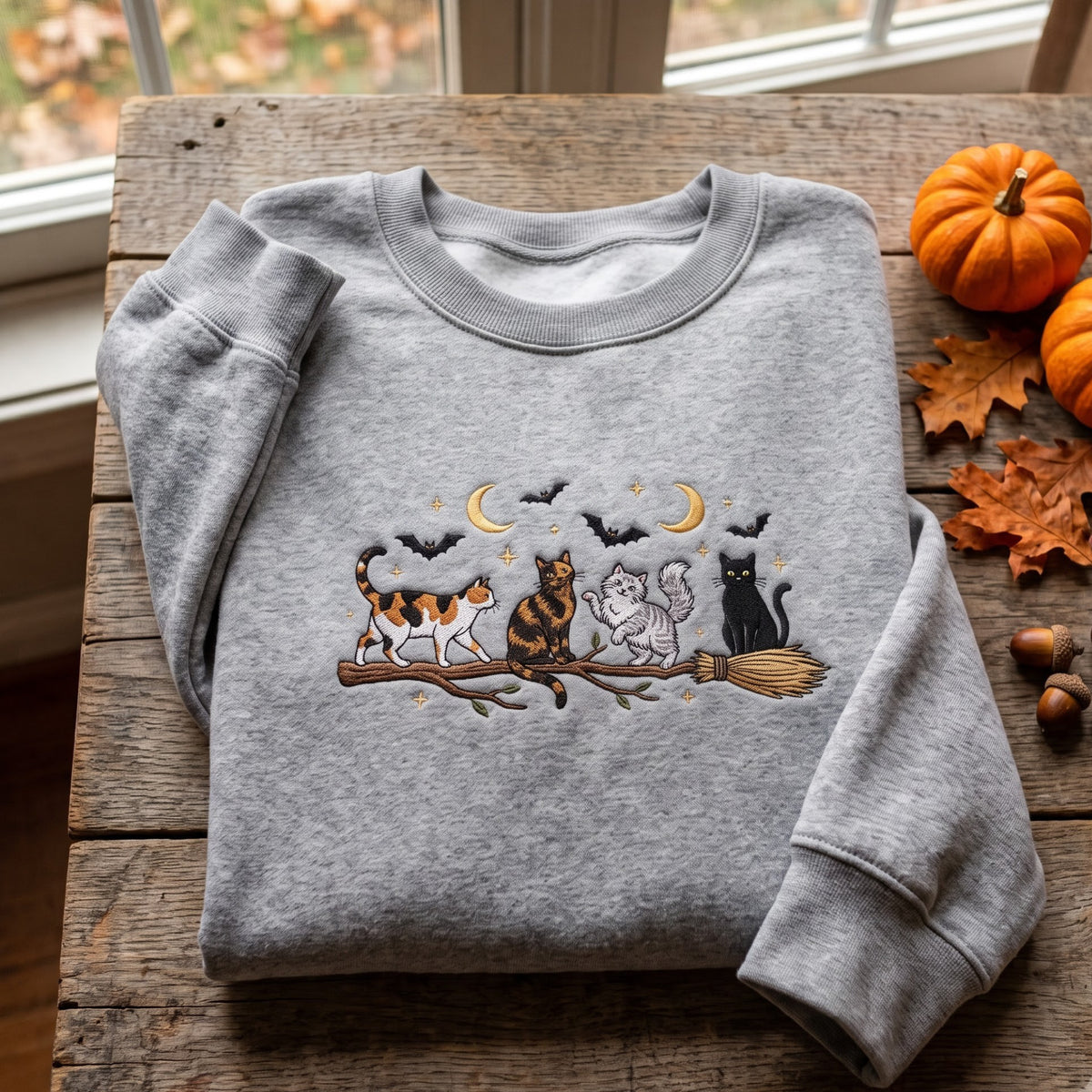 Cats on Broomstick Halloween Moon embroidered sweatshirt — front view
