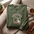 Midnight Reader Goose Window Moon embroidered sweatshirt — front view