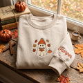 Cozy Ghost Reading Book Beanie Autumn Leaves embroidered sweatshirt — front view