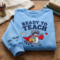 Personalized Teacher Superhero Raccoon Cape Books Apple Ready to Teach embroidered sweatshirt — front view