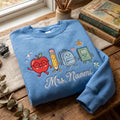 Personalized Teacher Name School Supplies Friends Holding Hands Apple Pencil Backpack embroidered sweatshirt — front view