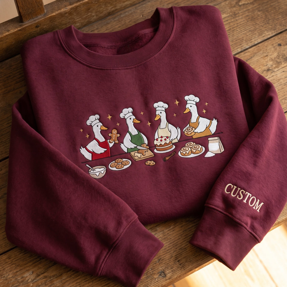 Personalized Baking Geese Chef Hat Apron Gingerbread Cinnamon Roll Christmas embroidered sweatshirt — front view