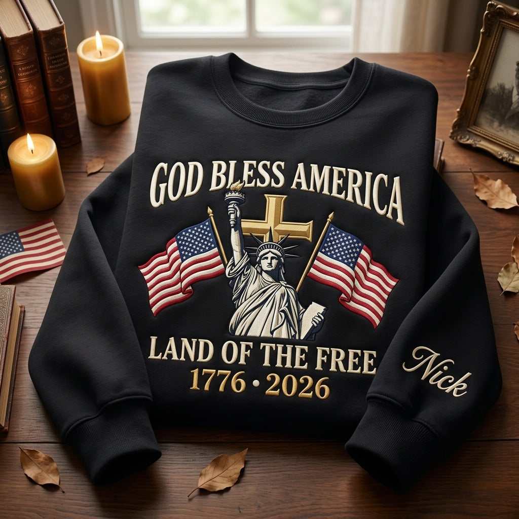 Personalized God Bless America Land of the Free 1776 2026 Statue of Liberty Cross Flags Faith Patriotic embroidered sweatshirt — front view