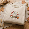Ghost Reading Book Mushroom Pumpkin Autumn Leaves Acorn Fall embroidered sweatshirt — front view