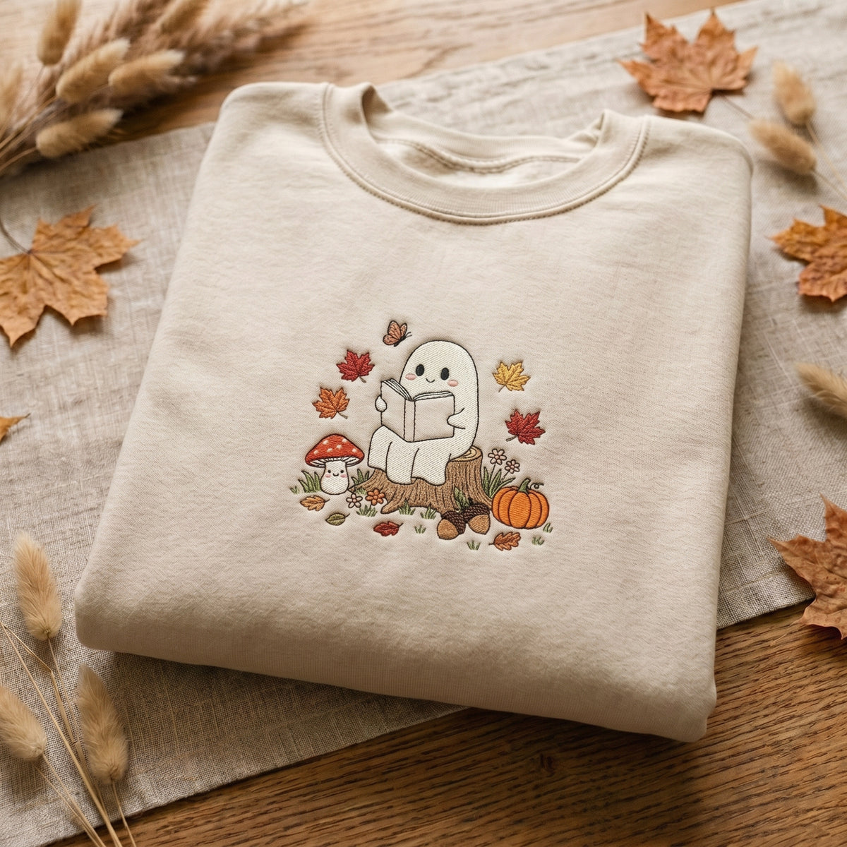 Ghost Reading Book Mushroom Pumpkin Autumn Leaves Acorn Fall embroidered sweatshirt — front view