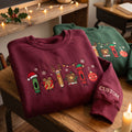 Personalized Christmas Teacher Crayon Pencil Book Ornament Santa Hat embroidered sweatshirt — front view