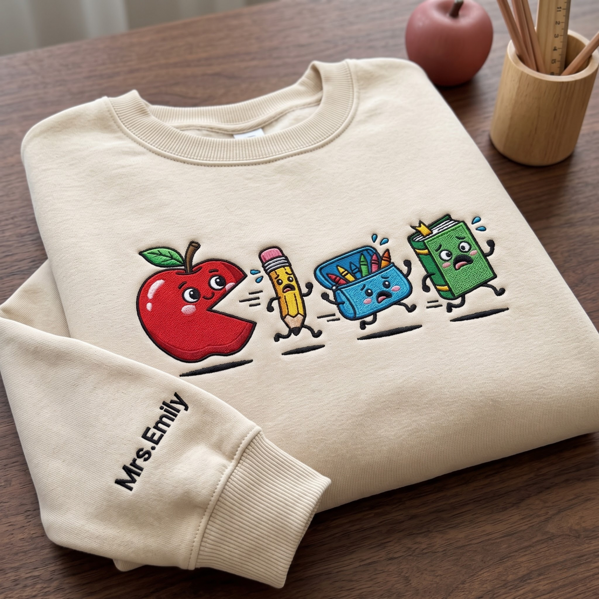 Personalized Teacher Apple Pac-Man Pencil Crayon Book Running embroidered sweatshirt — front view