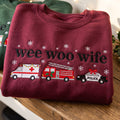 Wee Woo Wife Christmas Ambulance Fire Truck Police Car Snowflakes embroidered sweatshirt — front view