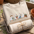 Gardening Geese Watering Can Flower Pot Shovel Wheelbarrow embroidered sweatshirt — front view