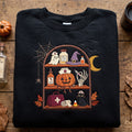 Halloween Nurse Pumpkin Spooky Bookshelf Ghost Black Cat Skeleton Hand embroidered sweatshirt — front view