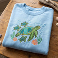 Sea Turtle Mom Baby Ocean Coral Seaweed Underwater embroidered sweatshirt — front view