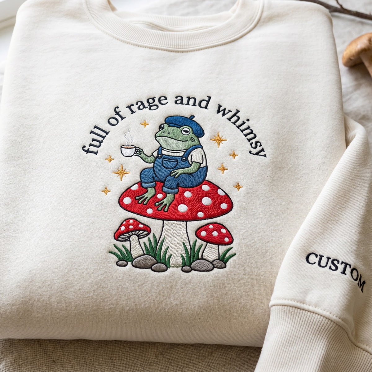 Full of Rage and Whimsy Frog Mushroom Coffee Cottagecore embroidered sweatshirt — front view