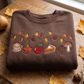 Autumn Branch Hanging Coffee Maple Leaf Apple Pie Pinecone Mushroom embroidered sweatshirt — front view