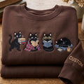 Personalized Black Cat Reading Books Cozy Blanket Glasses Kindle Coffee embroidered sweatshirt — front view