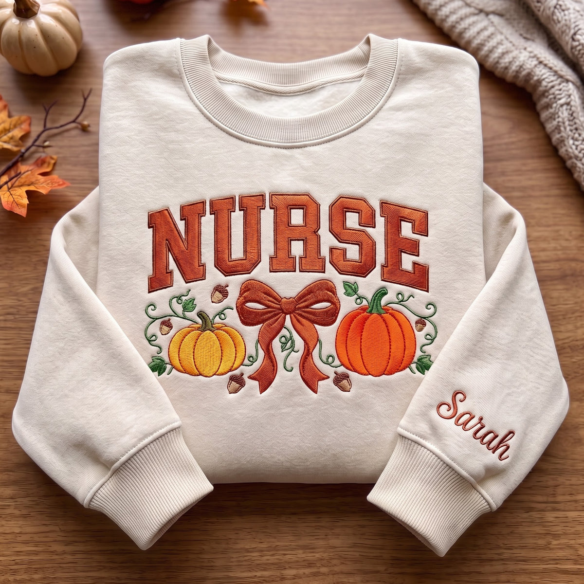 Personalized Fall Nurse Pumpkins Coquette Bow Acorns Vines Sleeve Name embroidered sweatshirt — front view