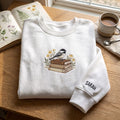 Personalized Chickadee Bird Stack of Books Wildflowers Bookworm embroidered sweatshirt — front view
