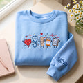 Personalized Nurse Medical Characters Heart Stethoscope Bandage Pill Clipboard embroidered sweatshirt — front view