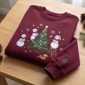 Christmas Snowmen Decorating Tree Stars Snowflakes Holiday embroidered sweatshirt — front view