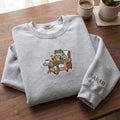 Personalized Frog Reading Book Armchair Coffee Cozy embroidered sweatshirt — front view