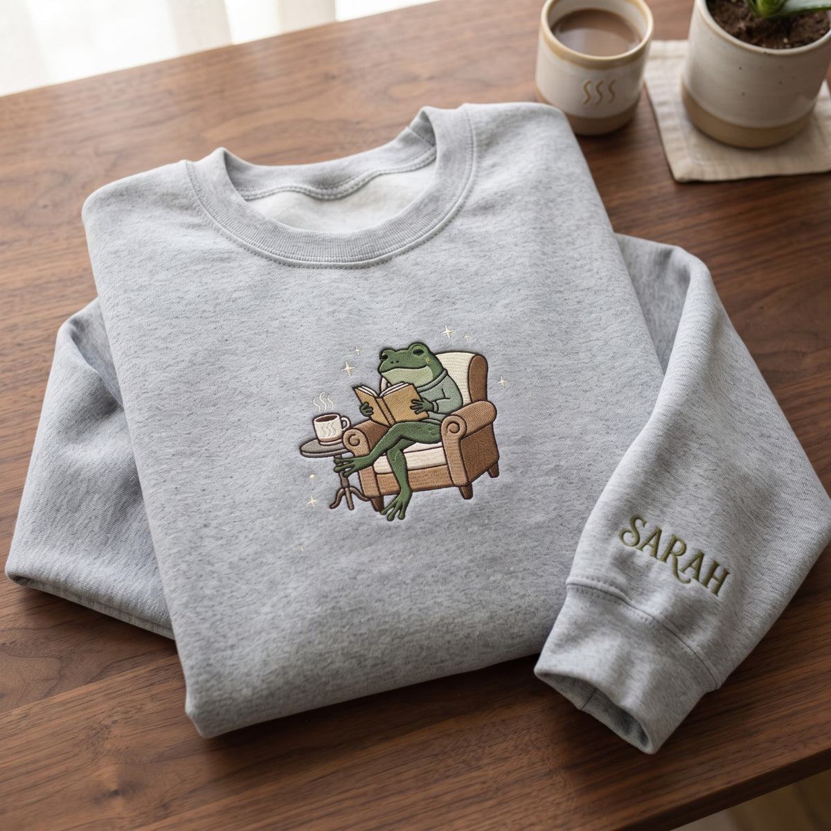 Personalized Frog Reading Book Armchair Coffee Cozy embroidered sweatshirt — front view