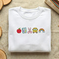 To School Apple Notebook Scissors School Bus Rainbow Kawaii embroidered sweatshirt — front view