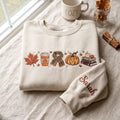 Personalized Cozy Fall Autumn Maple Leaf Pumpkin Latte Scarf Books Candle Sleeve Name embroidered sweatshirt — front view