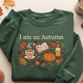 Personalized I Am an Autumn Cozy Fall Tea Cup Book Pumpkin Candle Leaves embroidered sweatshirt — front view