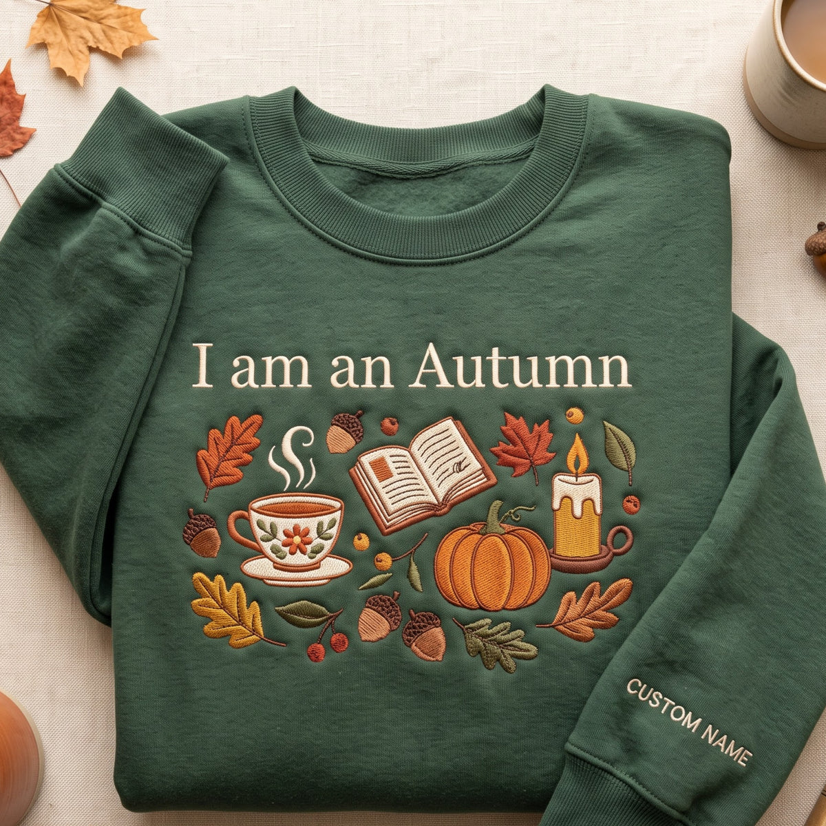 Personalized I Am an Autumn Cozy Fall Tea Cup Book Pumpkin Candle Leaves embroidered sweatshirt — front view