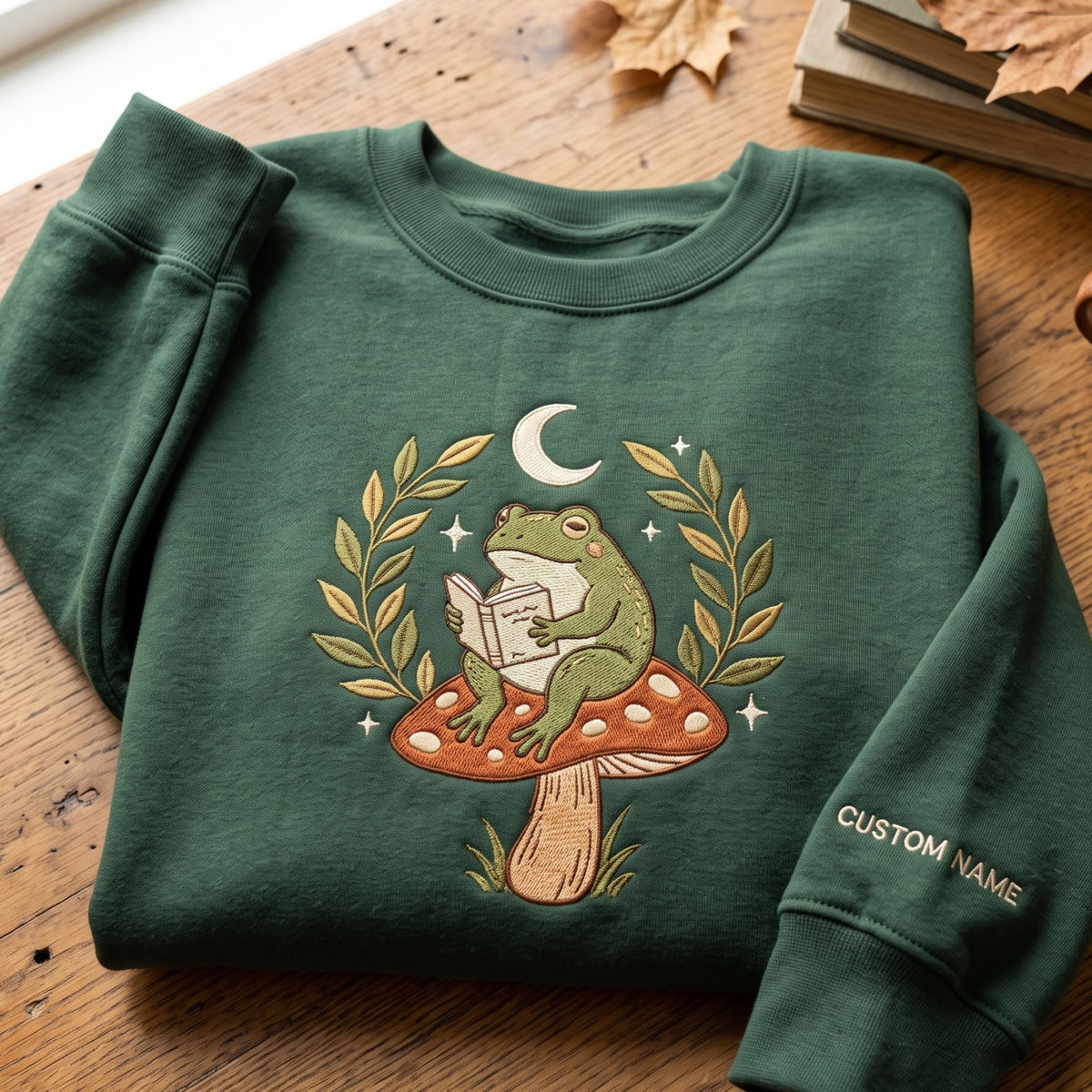 Personalized Frog Reading Book Mushroom Moon Cottagecore embroidered sweatshirt — front view