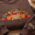 Personalized Fall Harvest Basket Pumpkins Apples Autumn Leaves Acorns embroidered sweatshirt — front view