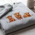 Three Highland Cows Floral Thistle embroidered sweatshirt — front view