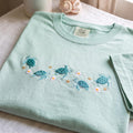Sea Turtles Daisies Stars Coastal Ocean embroidered t-shirt — front view