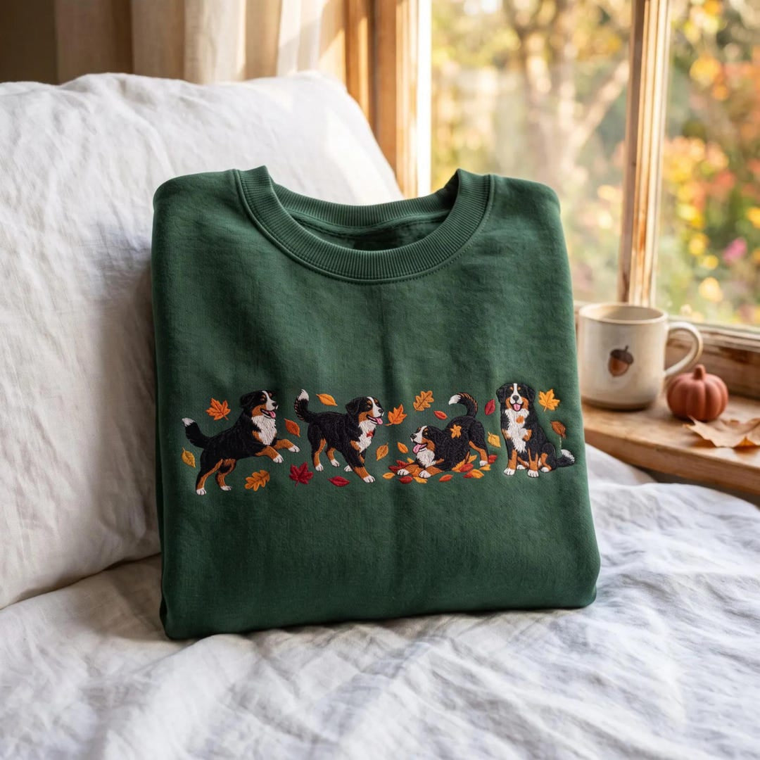 Bernese Mountain Dog Autumn Fall Leaves Playing Sitting embroidered sweatshirt — front view
