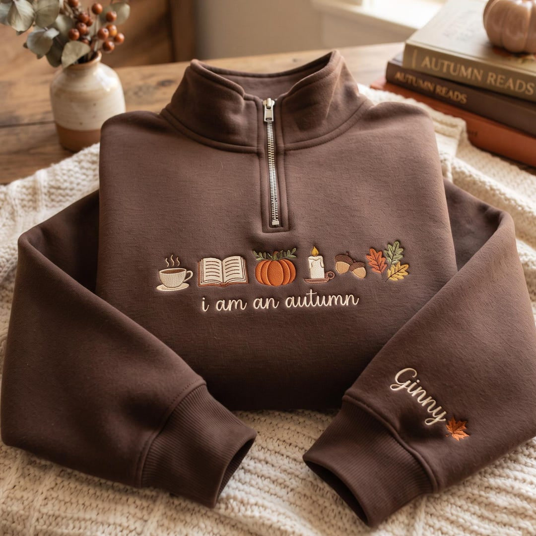 Personalized I Am an Autumn Coffee Book Pumpkin Candle Acorn Leaves embroidered sweatshirt — front view