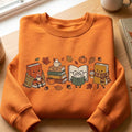 Autumn Fall Cozy Book Characters Pumpkin Acorn Leaves Coffee embroidered sweatshirt — front view