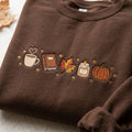 Fall Coffee Book Maple Leaf Candle Pumpkin Stars Autumn Vibes embroidered sweatshirt — front view
