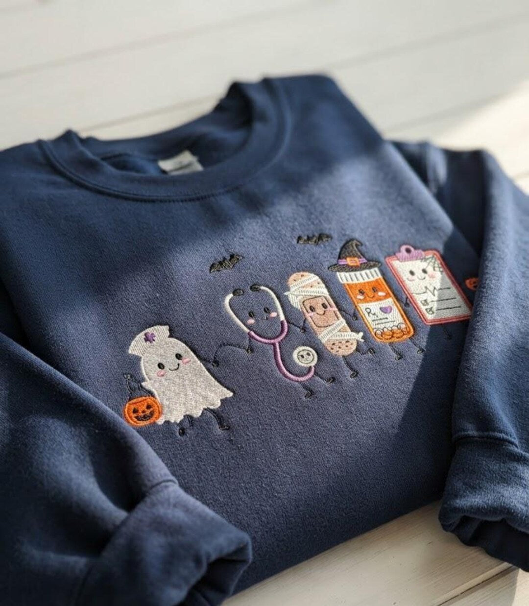 Halloween Nurse Ghost Stethoscope Mummy Pill Bottle Clipboard Spooky embroidered sweatshirt — front view
