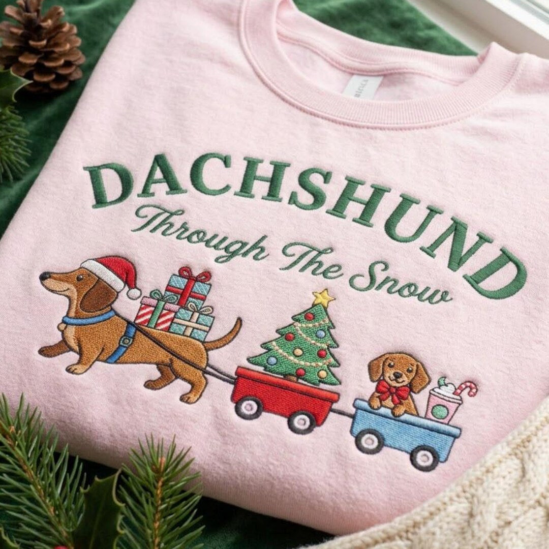 Dachshund Through the Snow Christmas Wiener Dog Pulling Wagons Holiday embroidered sweatshirt — front view