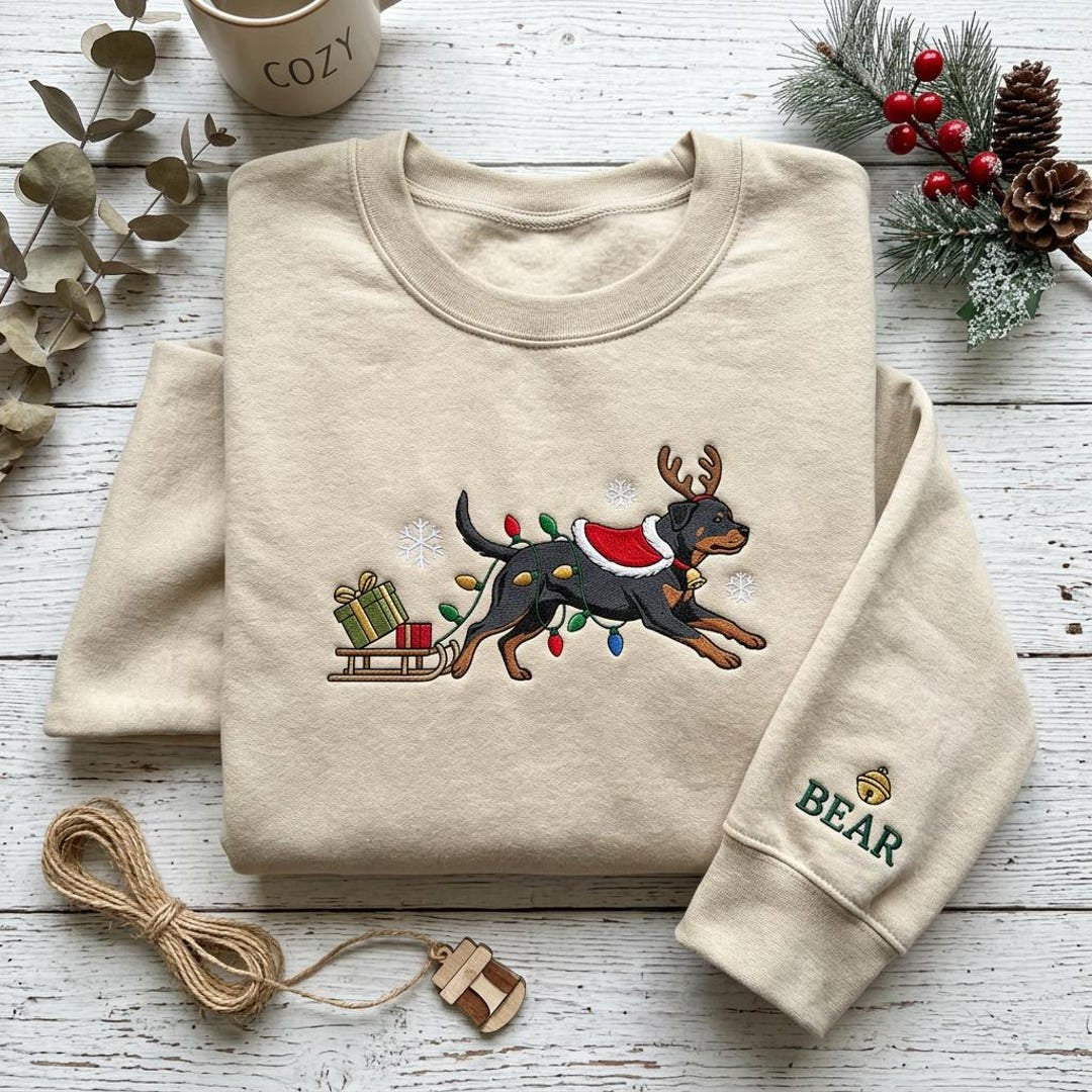 Personalized Rottweiler Christmas Reindeer Antlers Lights Sled Dog Name Sleeve embroidered sweatshirt — front view